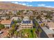 Aerial view of a home featuring solar panels, mature palm trees, and well maintained landscaping at 1407 Fields St, Las Vegas, NV 89142