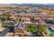 Aerial view of the backyard featuring a pool, fire pit, palm trees, and well-maintained turf at 1407 Fields St, Las Vegas, NV 89142