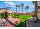 Backyard with a grassy area, landscaping, sidewalk and an American flag on a sunny day at 1407 Fields St, Las Vegas, NV 89142