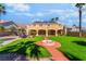 Backyard with a grassy area, landscaping, sidewalk, water feature and a view of the home on a sunny day at 1407 Fields St, Las Vegas, NV 89142