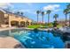 Backyard view of the pool, the patio, the trees and the grassy area behind the home on a sunny day at 1407 Fields St, Las Vegas, NV 89142