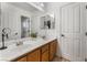 Bathroom featuring double sinks, neutral decor, and ample storage at 1407 Fields St, Las Vegas, NV 89142