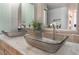 Close up of double sinks in an updated bathroom with marble countertops at 1407 Fields St, Las Vegas, NV 89142