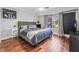 This primary bedroom features hardwood floors, a window, and neutral paint at 1407 Fields St, Las Vegas, NV 89142