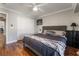 Primary bedroom boasts hardwood floors, a comfortable queen bed, and neutral decor at 1407 Fields St, Las Vegas, NV 89142