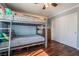 This bedroom features a bunk bed, hardwood floors, and neutral paint at 1407 Fields St, Las Vegas, NV 89142