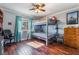 Comfortable bedroom with bunkbeds, hardwood floors, a ceiling fan, and a window with a view at 1407 Fields St, Las Vegas, NV 89142