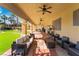Spacious covered patio featuring ceiling fans, outdoor seating, and a view of the lush backyard at 1407 Fields St, Las Vegas, NV 89142