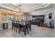 Dining room with large windows and modern chandelier leading to living room at 1407 Fields St, Las Vegas, NV 89142