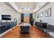 Dining area with hardwood floors, modern lighting fixture, and large window with natural light at 1407 Fields St, Las Vegas, NV 89142