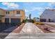 Long driveway leads to a well-maintained two-story home with three-car garage at 1407 Fields St, Las Vegas, NV 89142