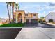 Charming two-story home with lush landscaping and a spacious three-car garage at 1407 Fields St, Las Vegas, NV 89142