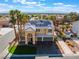 Stunning two-story home with a three-car garage, solar panels, and vibrant landscaping at 1407 Fields St, Las Vegas, NV 89142