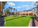 Well-maintained backyard with artificial turf, water feature, and a view of the home's exterior at 1407 Fields St, Las Vegas, NV 89142
