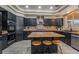 Stylish kitchen with stainless steel appliances, an island with seating, and ample counter space at 1407 Fields St, Las Vegas, NV 89142