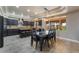 Modern kitchen with an island and stainless steel appliances, adjacent to a dining area with seating at 1407 Fields St, Las Vegas, NV 89142