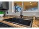 Close up of kitchen sink with black faucet and granite countertop at 1407 Fields St, Las Vegas, NV 89142