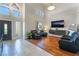 Spacious living room with tile and hardwood flooring, high ceilings, and comfortable leather seating at 1407 Fields St, Las Vegas, NV 89142
