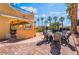 An outdoor kitchen and dining area, perfect for enjoying meals while overlooking the pool and lush backyard at 1407 Fields St, Las Vegas, NV 89142
