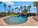 Sparkling pool with rock features surrounded by mature trees and lush landscaping at 1407 Fields St, Las Vegas, NV 89142