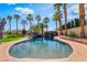 Inviting swimming pool with rock features and lush landscaping, perfect for relaxation at 1407 Fields St, Las Vegas, NV 89142