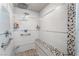 Updated shower featuring a bench and a pebble accent wall at 1407 Fields St, Las Vegas, NV 89142