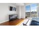 This is a bedroom with hard wood floors, a dresser, a wall-mounted TV, and sliding glass doors to a balcony at 150 Las Vegas Blvd # 1608, Las Vegas, NV 89101