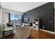 Living room showcasing modern black accent wall, city views and hardwood floors at 150 Las Vegas Blvd # 1608, Las Vegas, NV 89101