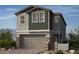 Charming home featuring a two-car garage and a blend of stone and siding accents at 155 Silver Run Ln, Las Vegas, NV 89138