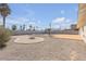 Wide backyard view showcasing gravel, desert landscaping, patio, pool, and a surrounding block fence at 1616 Yellow Rose St, Las Vegas, NV 89108