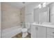 Bathroom featuring a tub with light marble surround, modern vanity, and stylish fixtures at 1616 Yellow Rose St, Las Vegas, NV 89108