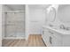 Modern bathroom with dual sinks, a glass-enclosed shower, and updated fixtures at 1616 Yellow Rose St, Las Vegas, NV 89108