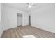 Bright bedroom with ceiling fan, wood-look floors, and a sliding closet door at 1616 Yellow Rose St, Las Vegas, NV 89108