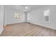 Large bedroom featuring wood-look flooring, ceiling fan, and abundant natural light at 1616 Yellow Rose St, Las Vegas, NV 89108