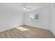 Well-lit bedroom with a ceiling fan, wood-look floors, and large window at 1616 Yellow Rose St, Las Vegas, NV 89108