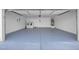 Spacious garage with painted floors, ample storage, washer, dryer, and a water heater at 1616 Yellow Rose St, Las Vegas, NV 89108