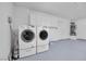A well-organized garage with washer, dryer, storage cabinets, painted floors, and a water heater at 1616 Yellow Rose St, Las Vegas, NV 89108