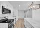 Charming kitchen area with stainless steel appliances and overhead lights above island at 1616 Yellow Rose St, Las Vegas, NV 89108