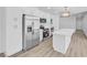 Bright, white kitchen with an island, stainless steel appliances, and new cabinetry at 1616 Yellow Rose St, Las Vegas, NV 89108