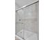 Modern bathroom shower with glass doors and light marble surround at 1616 Yellow Rose St, Las Vegas, NV 89108