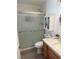 Well-lit bathroom featuring a shower with glass doors, modern vanity, and white tiling at 1826 Dunes Ct, Laughlin, NV 89029