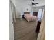 Bright primary bedroom with a ceiling fan and sliding glass doors at 1826 Dunes Ct, Laughlin, NV 89029