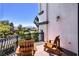 Relaxing balcony with two Adirondack chairs overlooking green landscaping and a distant mountain view at 2 Yorkridge Ct, Henderson, NV 89052