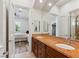 Double sink bathroom with custom wood cabinet and tile floor, looking out into a bedroom at 2 Yorkridge Ct, Henderson, NV 89052