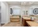 Bright bathroom with tile floors, arched tub, and double vanity with countertop space at 2 Yorkridge Ct, Henderson, NV 89052