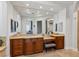 Spacious bathroom vanity with tile floors, wood cabinets and large mirror at 2 Yorkridge Ct, Henderson, NV 89052