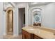 Luxurious bathroom with stone shower, arched doorways, and ample vanity space at 2 Yorkridge Ct, Henderson, NV 89052
