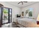 Bright bedroom features a tray ceiling, wood floors, and French door leading to the backyard at 2 Yorkridge Ct, Henderson, NV 89052