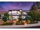 Stunning two-story home with manicured landscaping, elegant lighting, and a circular driveway at 2 Yorkridge Ct, Henderson, NV 89052
