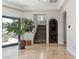 Inviting foyer boasts tile floors, a decorative front door, staircase, and natural light from large glass doors at 2 Yorkridge Ct, Henderson, NV 89052